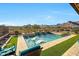 Modern pool and spa with a mountain view and lounge chairs at 5566 N 206Th Gln, Buckeye, AZ 85396