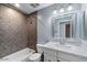 Bathroom with gray tile, white vanity, and bathtub at 7447 E Christmas Cholla Dr, Scottsdale, AZ 85255