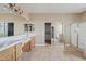 Large bathroom with double sinks, a walk-in closet, and shower at 7603 W Encinas Ln, Phoenix, AZ 85043