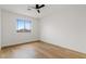 Bright bedroom with hardwood floors and large window at 7603 W Encinas Ln, Phoenix, AZ 85043