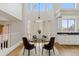 Bright dining room with modern chandelier, large windows, and neutral decor at 7603 W Encinas Ln, Phoenix, AZ 85043