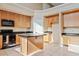 Spacious kitchen featuring an island, ample cabinetry, and granite countertops at 7603 W Encinas Ln, Phoenix, AZ 85043