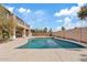 Inviting backyard pool surrounded by a concrete deck and framed by a home's exterior at 7603 W Encinas Ln, Phoenix, AZ 85043