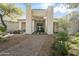 Elegant entryway with a stone facade and a charming water feature at 7610 N Mockingbird Ln, Paradise Valley, AZ 85253