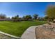 Expansive community lawn with walking path and lush landscaping at 8713 E Voltaire Ave, Scottsdale, AZ 85260