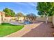 Expansive backyard with lush synthetic lawn, sparkling pool, and desert landscaping creates a private outdoor oasis at 1041 N 91St Pl, Mesa, AZ 85207