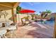 Outdoor patio with stylish seating area and an umbrella, perfect for entertaining and relaxing by the pool at 1041 N 91St Pl, Mesa, AZ 85207