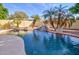 Backyard pool with waterfall feature, desert landscaping, ideal for outdoor enjoyment and relaxation at 1041 N 91St Pl, Mesa, AZ 85207