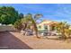 Tranquil backyard pool area with palm trees, rock features, and desert landscaping creates a private retreat at 1041 N 91St Pl, Mesa, AZ 85207