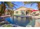 Stunning pool featuring rock waterfall and lush landscaping, a perfect setting for relaxation and entertainment at 1041 N 91St Pl, Mesa, AZ 85207