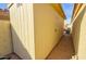 View of a shed in the backyard featuring light yellow siding and a secure door in a well-maintained outdoor space at 1041 N 91St Pl, Mesa, AZ 85207