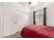 Bedroom with a red comforter and sliding door closet at 10454 E Peralta Canyon Dr, Gold Canyon, AZ 85118