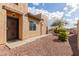 Home exterior showcasing a side entrance and desert landscaping at 10454 E Peralta Canyon Dr, Gold Canyon, AZ 85118