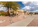 House exterior showcasing desert landscaping and a two-car garage at 10454 E Peralta Canyon Dr, Gold Canyon, AZ 85118