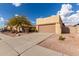 House exterior with a tan stucco finish and a two car garage at 10454 E Peralta Canyon Dr, Gold Canyon, AZ 85118