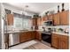 Well-equipped kitchen with stainless steel appliances and wood cabinets at 10454 E Peralta Canyon Dr, Gold Canyon, AZ 85118