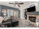 Cozy living room featuring a fireplace, comfy seating, and a large TV at 10454 E Peralta Canyon Dr, Gold Canyon, AZ 85118