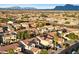 Aerial view of houses, palm trees and mountain backdrop at 10730 E Medina Ave, Mesa, AZ 85209