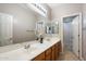 Bathroom features double sinks and wood cabinets at 10730 E Medina Ave, Mesa, AZ 85209