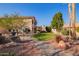 Landscaped backyard with a stone path, fountain, and lush greenery at 10921 W Bermuda Dr, Avondale, AZ 85392