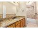 Bathroom with granite countertop, wood cabinets, and a bathtub at 10921 W Bermuda Dr, Avondale, AZ 85392