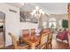 Bright dining room with a chandelier and adjacent living area at 10921 W Bermuda Dr, Avondale, AZ 85392