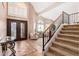 Elegant entryway with a staircase, tiled floors, and double doors at 10921 W Bermuda Dr, Avondale, AZ 85392