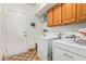 Laundry room with washer, dryer, and wood cabinets at 10921 W Bermuda Dr, Avondale, AZ 85392