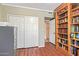 Home office with wood flooring, built-in shelving and closet at 10921 W Bermuda Dr, Avondale, AZ 85392