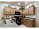 Modern kitchen featuring dark wood cabinets and stainless steel appliances at 10960 E Monte Ave # 196, Mesa, AZ 85209