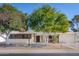 Charming single-story home featuring mature trees, desert landscaping, and a two-car garage at 11008 W Cherry Hills W Dr, Sun City, AZ 85351