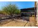 Covered patio, garden space, and fenced backyard at 12021 W Locust Ln, Avondale, AZ 85323