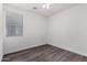 Bedroom with window, ceiling fan and wood-look floors at 12021 W Locust Ln, Avondale, AZ 85323