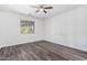 Spacious bedroom with wood-look floors and ceiling fan at 12021 W Locust Ln, Avondale, AZ 85323