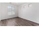 Bright bedroom with large window and wood-look floors at 12021 W Locust Ln, Avondale, AZ 85323