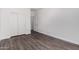 Bedroom with double door closet and wood-look floors at 12021 W Locust Ln, Avondale, AZ 85323