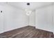 Bright dining room features wood-look floors and a modern chandelier at 12021 W Locust Ln, Avondale, AZ 85323