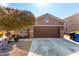 Single-story home with brown garage door and landscaping at 12021 W Locust Ln, Avondale, AZ 85323