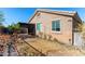 Tan house exterior with a backyard and patio at 12021 W Locust Ln, Avondale, AZ 85323