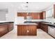 Island kitchen with dark wood cabinets and granite countertops at 12021 W Locust Ln, Avondale, AZ 85323