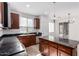 Kitchen features dark wood cabinets, granite counters, and stainless steel appliances at 12021 W Locust Ln, Avondale, AZ 85323