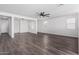 Spacious living room with hardwood floors and ceiling fan at 12021 W Locust Ln, Avondale, AZ 85323