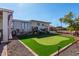 Backyard with putting green, gravel landscaping, and storage shelves at 12406 W Allegro Dr, Sun City West, AZ 85375