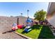 -friendly backyard with play structures, picnic table, and grassy area at 12406 W Allegro Dr, Sun City West, AZ 85375