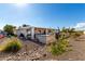 Backyard view showcasing patio, grill, and landscaping at 12406 W Allegro Dr, Sun City West, AZ 85375