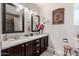 Bathroom with double vanity, granite countertop, and framed art at 12406 W Allegro Dr, Sun City West, AZ 85375