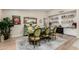 Elegant dining room with a rustic wooden table and green upholstered chairs at 12406 W Allegro Dr, Sun City West, AZ 85375