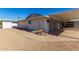 Side view of the house showing the carport and landscaping at 12406 W Allegro Dr, Sun City West, AZ 85375