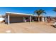 House exterior featuring carport, landscaping, and palm trees at 12406 W Allegro Dr, Sun City West, AZ 85375