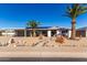 House exterior showcasing carport, landscaping, and palm trees at 12406 W Allegro Dr, Sun City West, AZ 85375